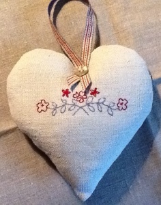 Scandinavian style heart in red and blue on vintage linen